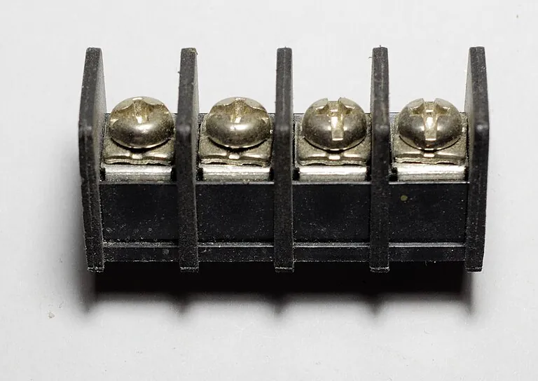 A black four-screw terminal block