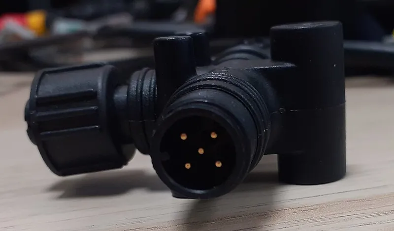 Close-up of a male NMEA 2000 port showing five pins inside a threaded shell