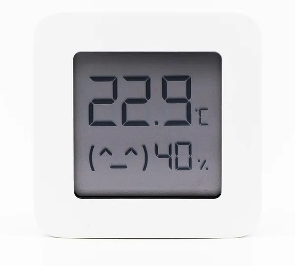 A small white Bluetooth temperature and humidity sensor with a display